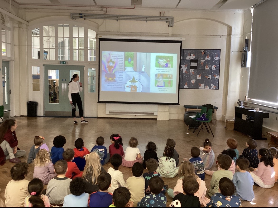 Author reading her rhyming picture book to a hall of primary school children